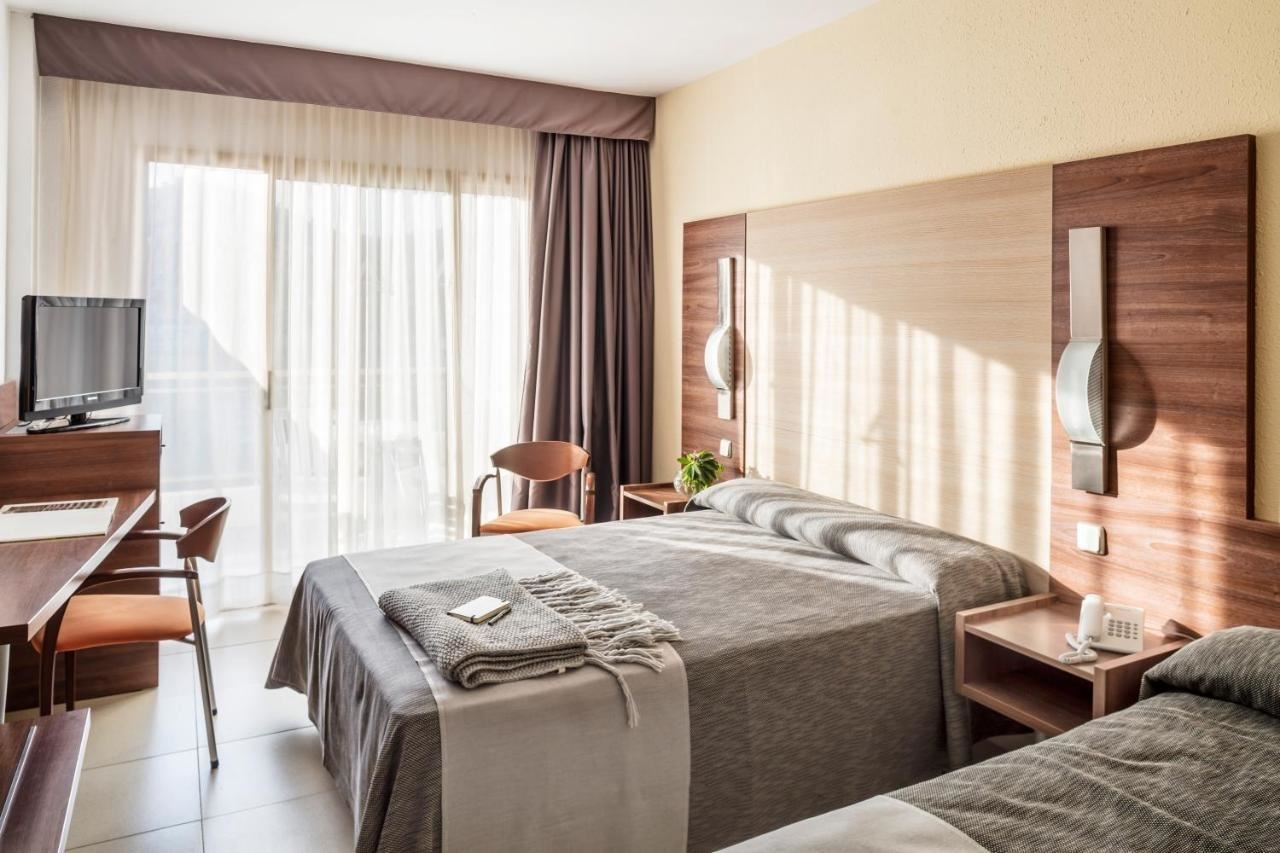 rooms-premium-triple-room-pool-view-or-partial-sea-view with-balcony